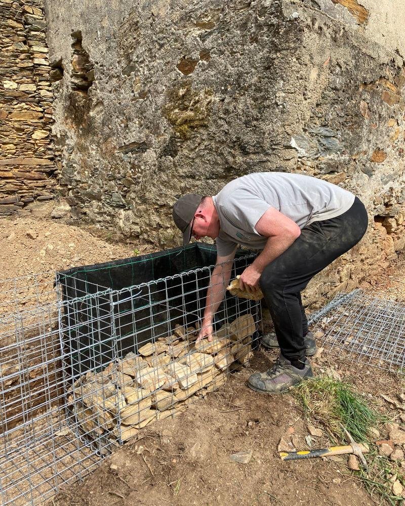 Gary loading up stones into the first gabion.