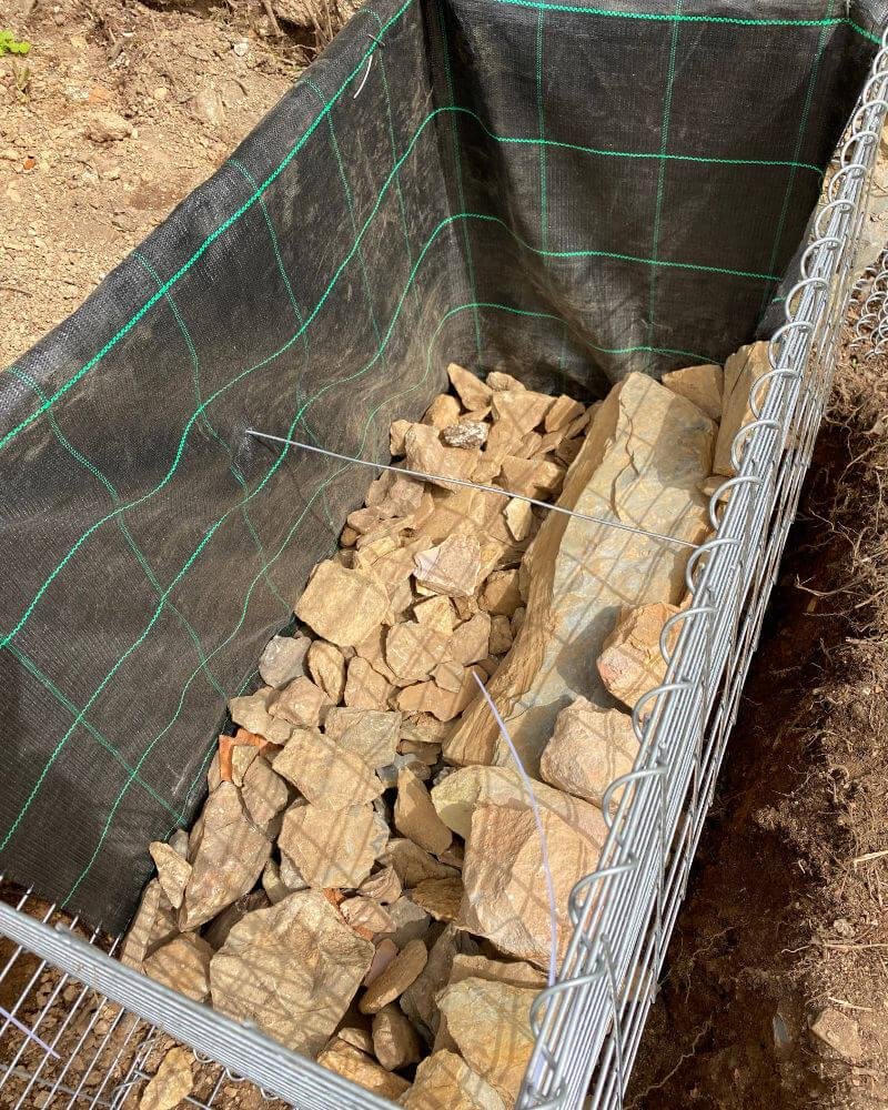 Gabion liner will prevent some of the soild falling through when we back-fill.