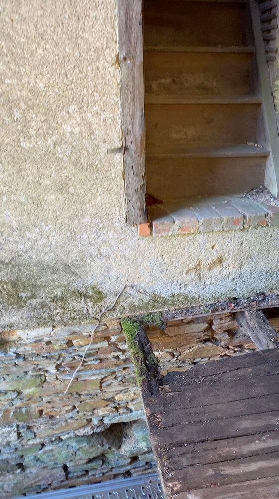 Rotten hallway floor leading to the loft area